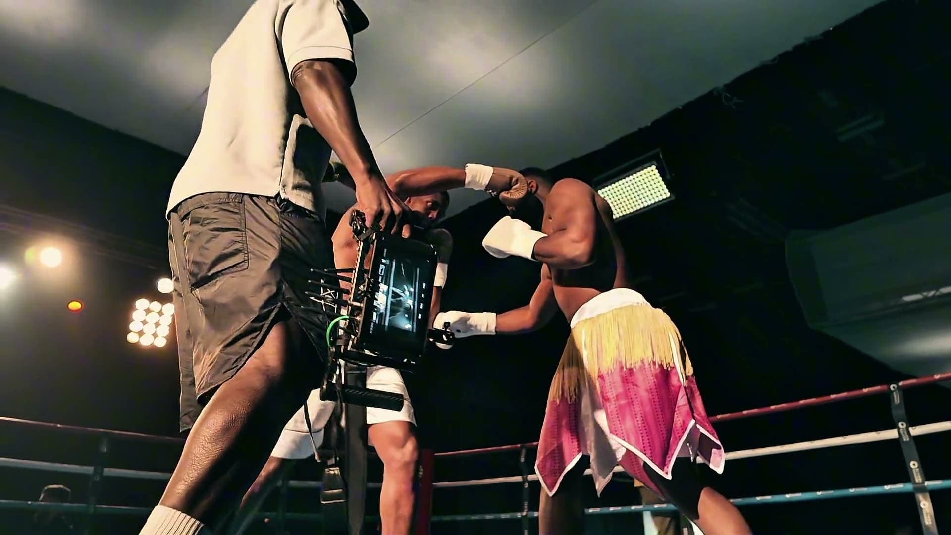 Operator filming a boxing set from the ring apron