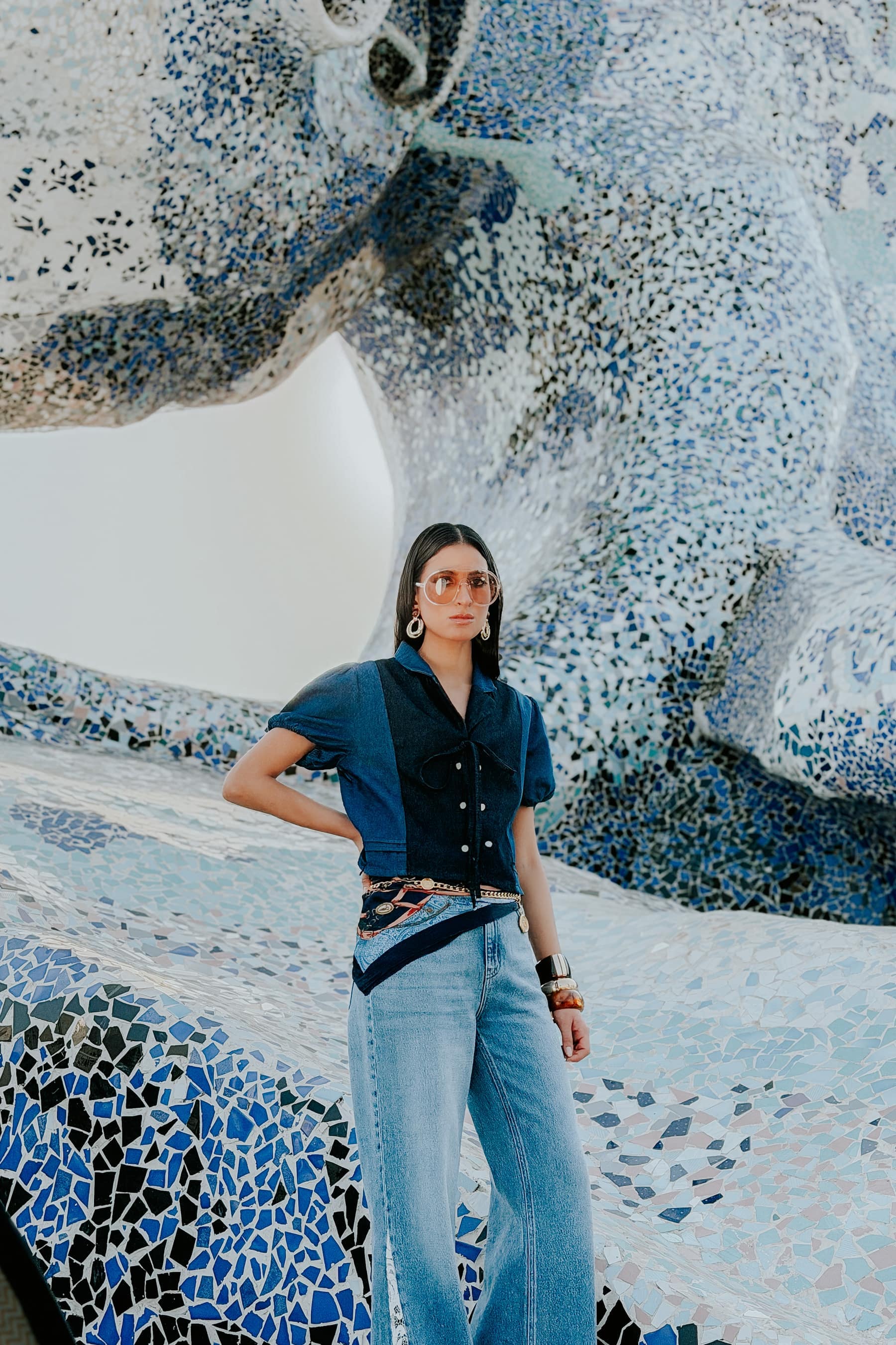 Full-length denim look against patterned mosaic