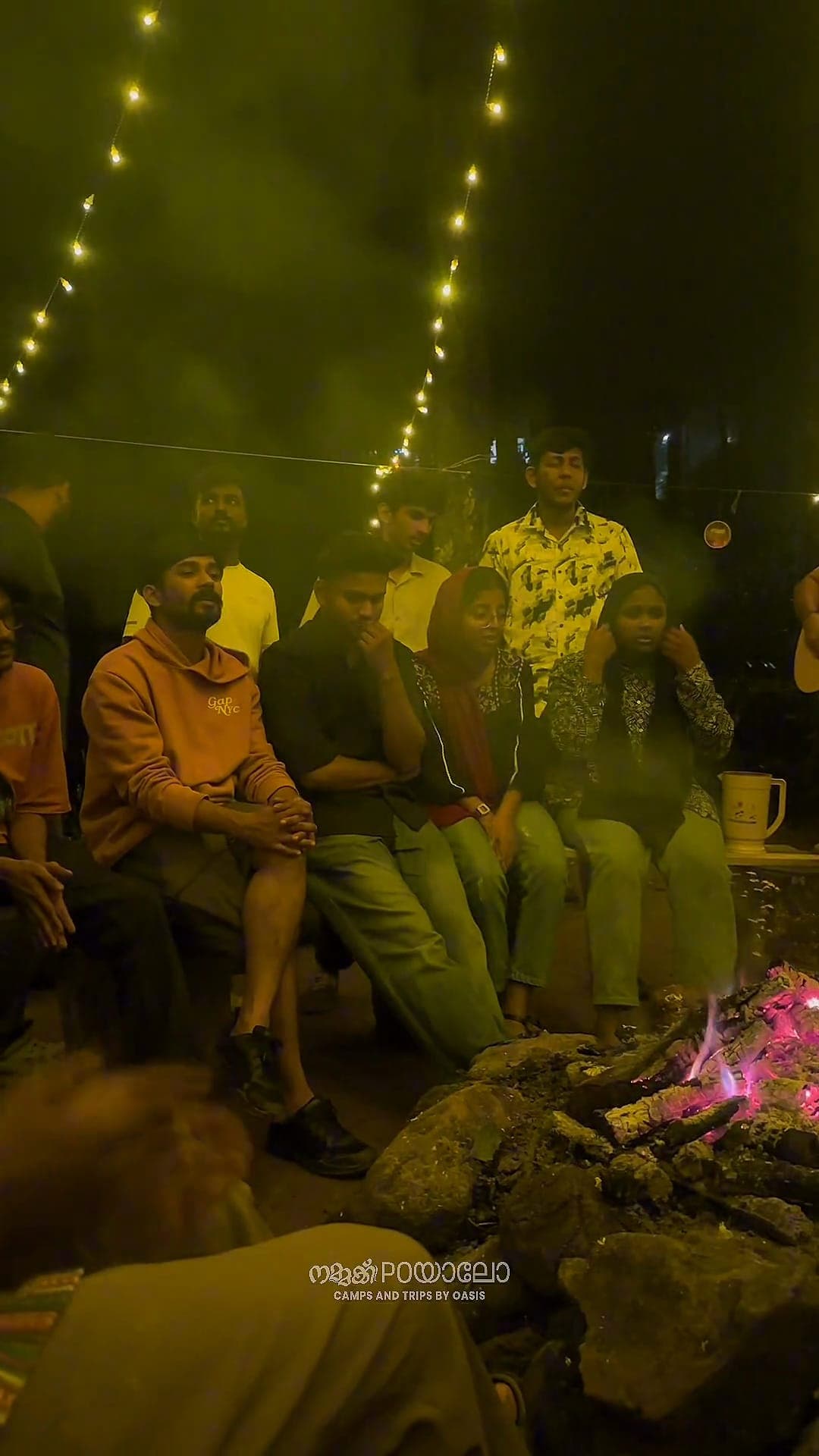 Campfire and string lights after dark